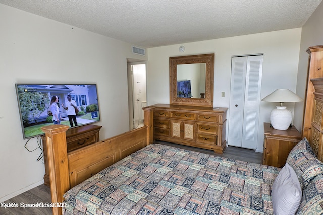 4700 Ocean Beach Blvd Unit 404, Cocoa Beach, FL 32931 - bedroom with wood finished floors, a closet, and a textured ceiling