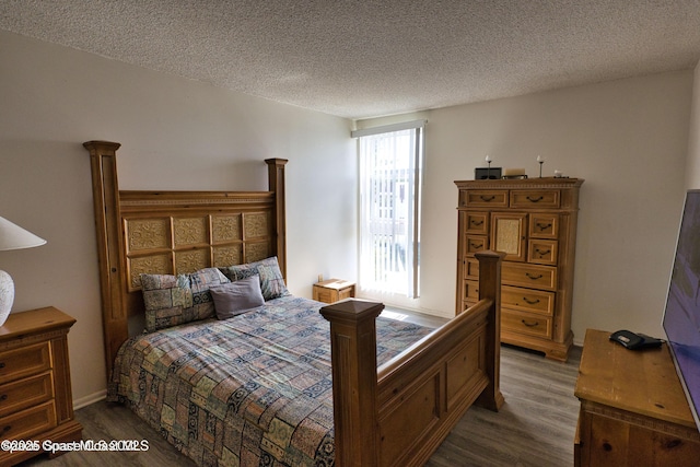 4700 Ocean Beach Blvd Unit 404, Cocoa Beach, FL 32931 - bedroom featuring wood finished floors and a textured ceiling
