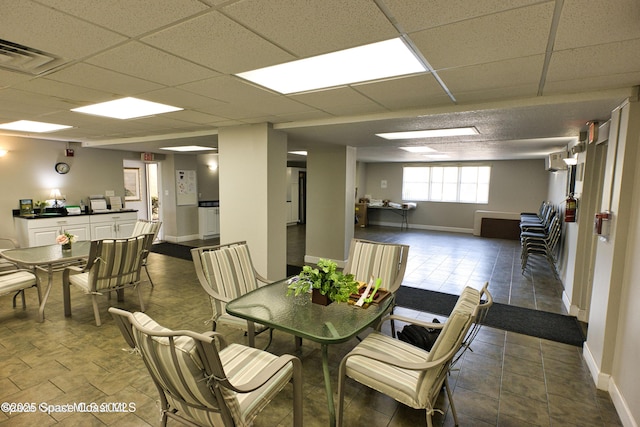 dining area featuring a drop ceiling