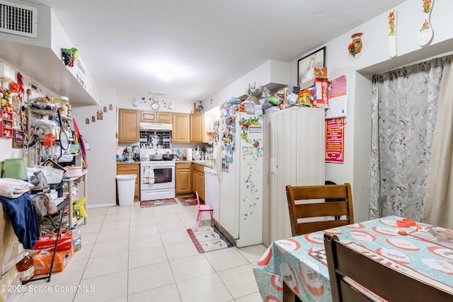 kitchen featuring light brown cabinets, white appliances, and light tile patterned floors