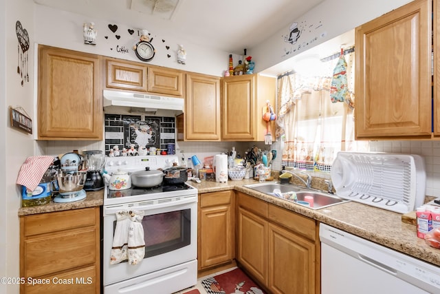 kitchen with decorative backsplash, sink, and white appliances