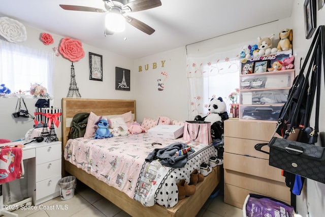 bedroom with ceiling fan and light tile patterned flooring