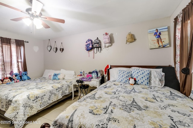 tiled bedroom featuring ceiling fan