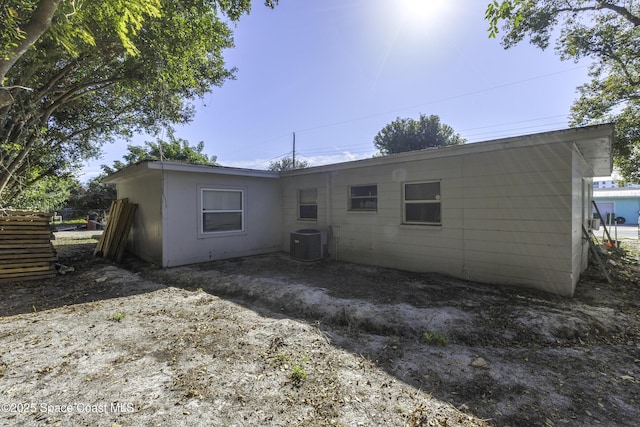 rear view of property featuring central AC unit