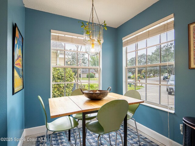 dining room with tile patterned flooring and a chandelier