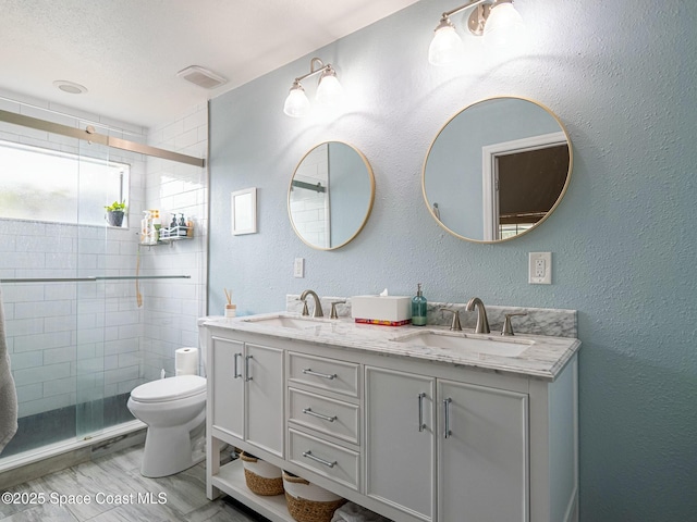 bathroom featuring walk in shower, vanity, and toilet