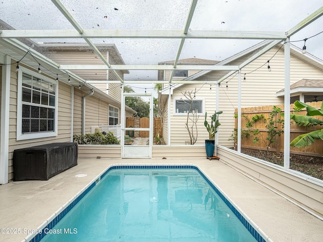 view of pool with a lanai and a patio