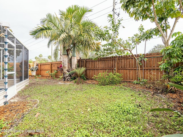 view of yard featuring glass enclosure