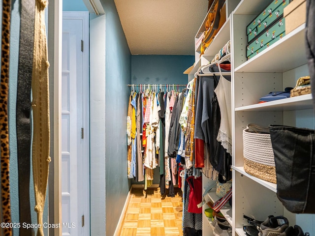 spacious closet featuring light parquet floors