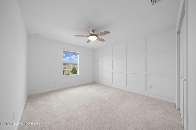 unfurnished room with ceiling fan and light colored carpet