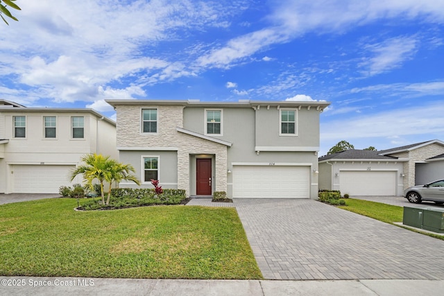 view of front of house featuring a front yard and a garage