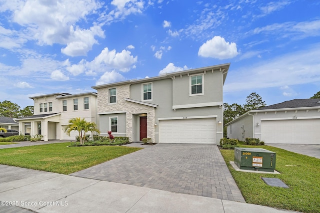 view of front of property with a garage and a front yard