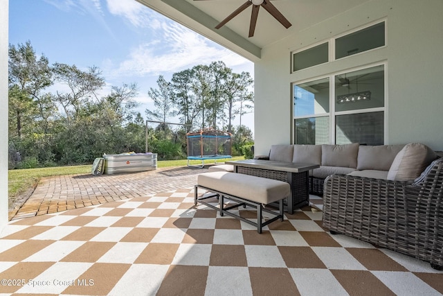 view of patio featuring an outdoor living space, a trampoline, and ceiling fan