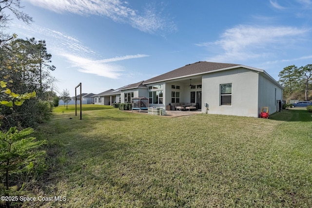 back of property with a patio area, ceiling fan, a yard, and outdoor lounge area