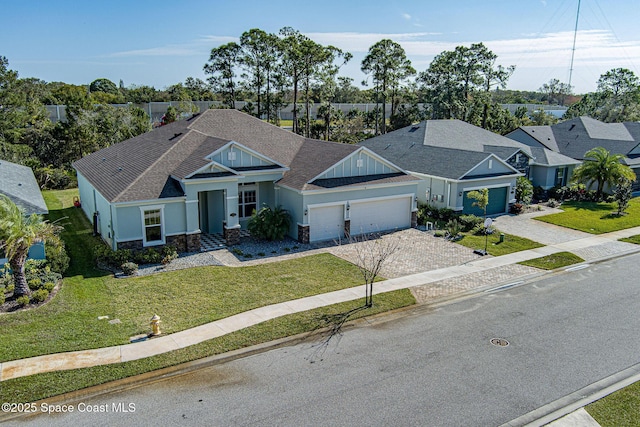 view of front of home with a front yard and a garage