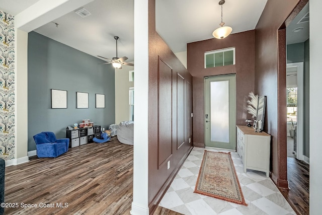 foyer entrance with ceiling fan