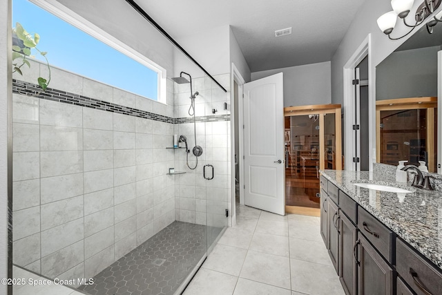 bathroom with tile patterned floors, vanity, and a shower with shower door