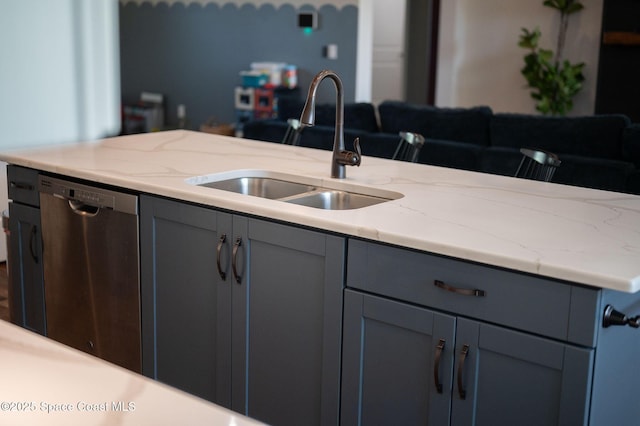 kitchen with gray cabinets, dishwasher, sink, and light stone countertops