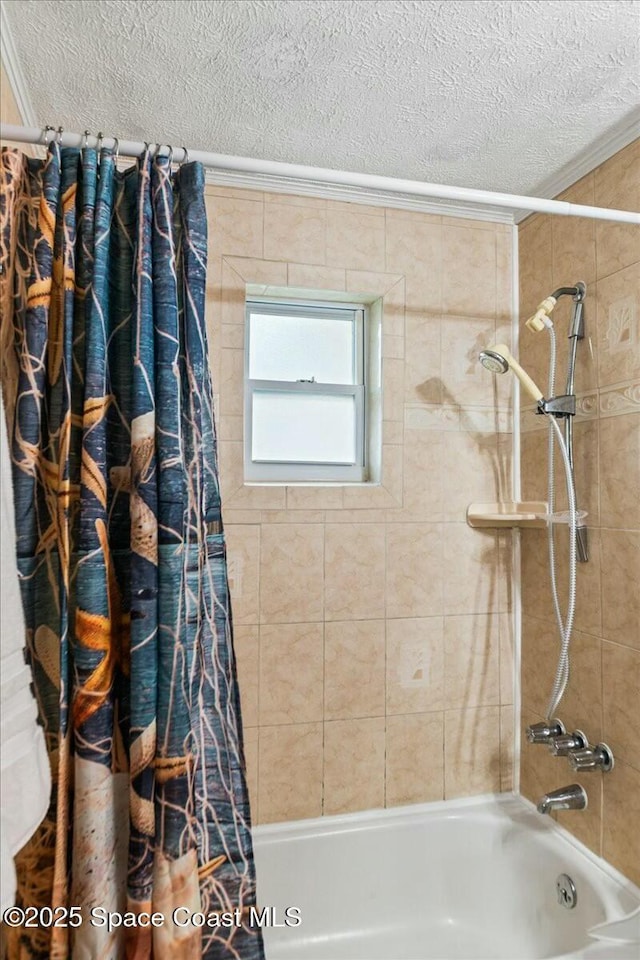 bathroom featuring a textured ceiling, crown molding, and shower / bath combo