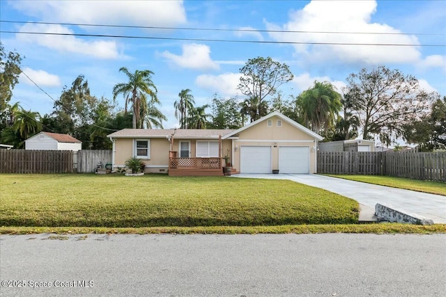 single story home featuring a garage and a front lawn