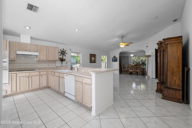 kitchen with light brown cabinets, sink, tasteful backsplash, kitchen peninsula, and white dishwasher