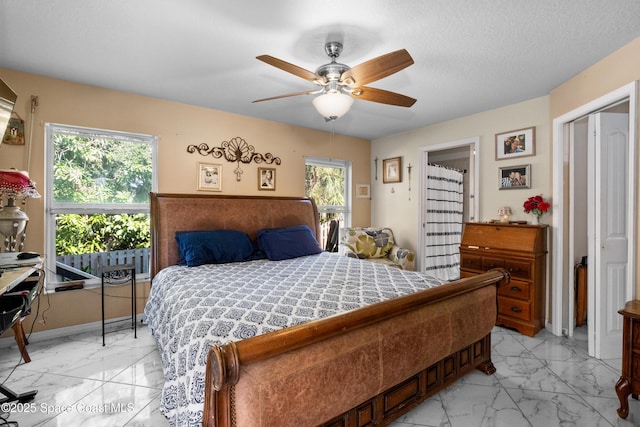 bedroom featuring multiple windows, ceiling fan, and a textured ceiling