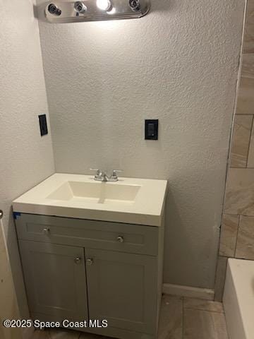 bathroom with vanity and a tub to relax in