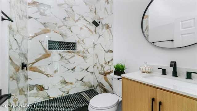 bathroom featuring a shower, vanity, and toilet