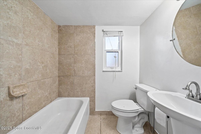 bathroom featuring toilet, tile patterned floors, and sink