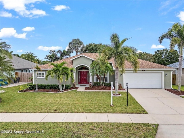 view of front of house with a garage and a front lawn