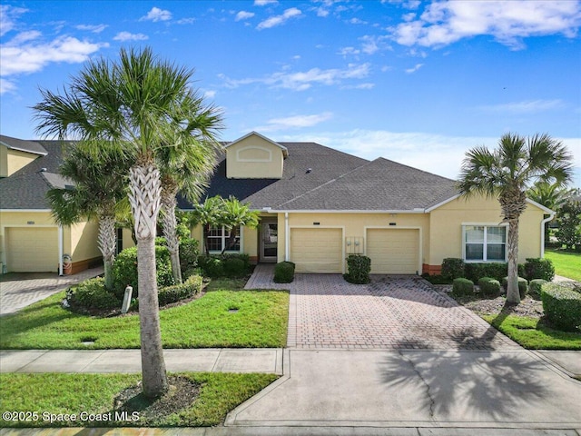 view of front of property featuring a garage and a front lawn