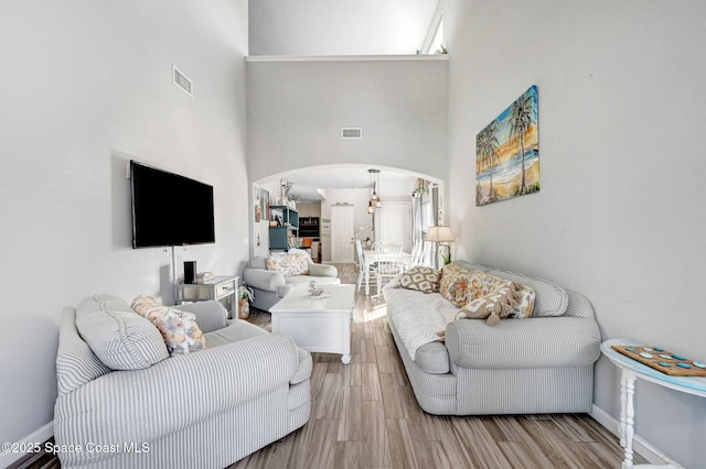 living room with an inviting chandelier and a high ceiling