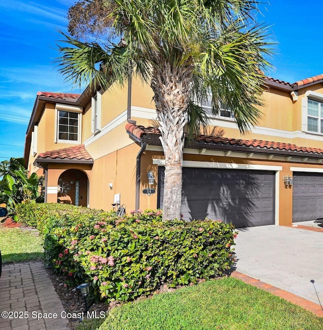 mediterranean / spanish-style house with a garage