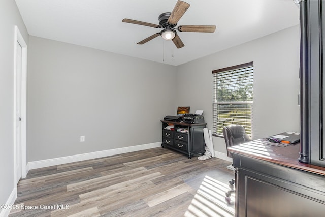 home office with hardwood / wood-style floors and ceiling fan