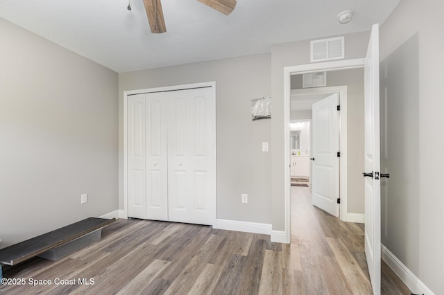 unfurnished bedroom featuring a closet, ceiling fan, and light hardwood / wood-style floors