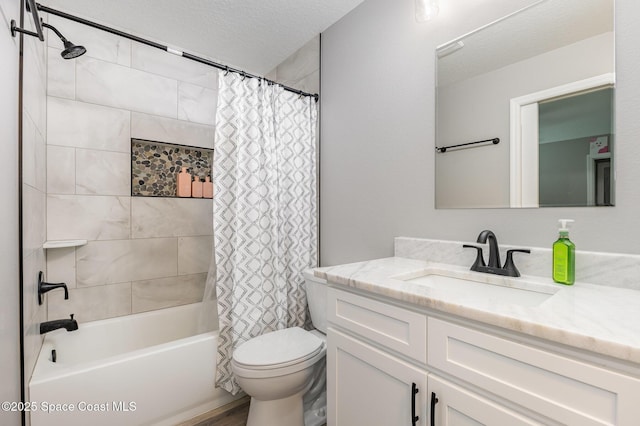 full bathroom featuring toilet, vanity, a textured ceiling, and shower / tub combo with curtain