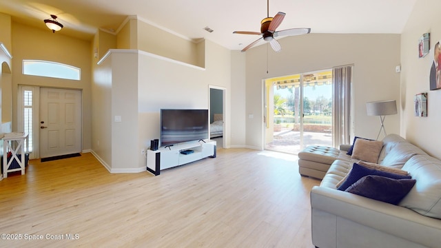 living room with ceiling fan, light wood-type flooring, and high vaulted ceiling