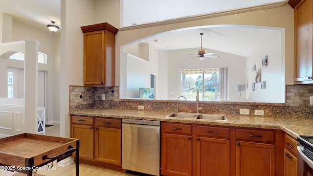 kitchen with dishwasher, sink, vaulted ceiling, ceiling fan, and tasteful backsplash