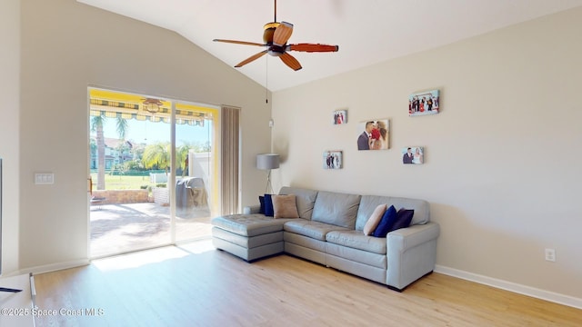 living room with ceiling fan, light wood-type flooring, and vaulted ceiling