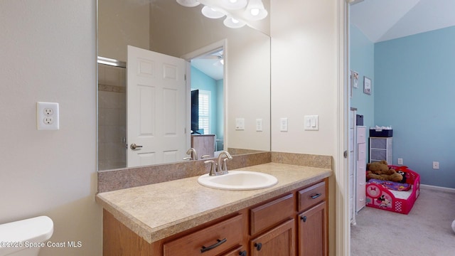 bathroom with vanity, toilet, lofted ceiling, and a shower with door