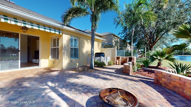 view of property exterior with a patio area