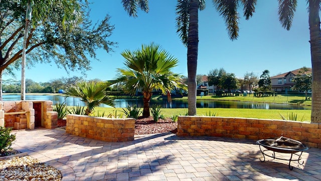 view of patio featuring a fire pit and a water view