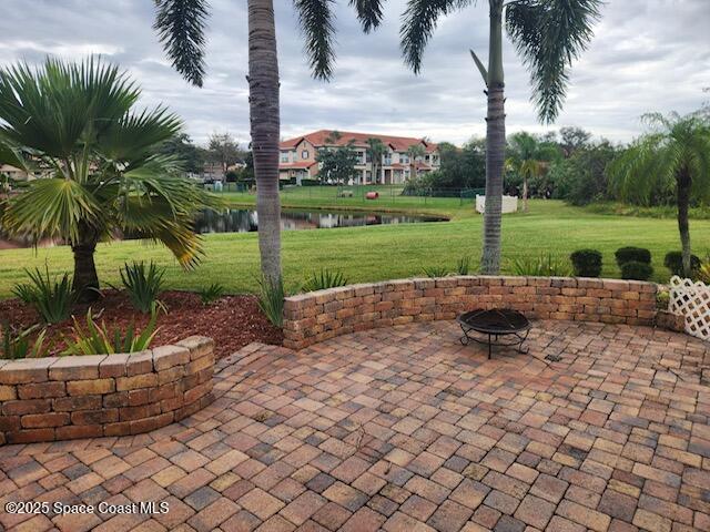 view of patio featuring a water view and an outdoor fire pit