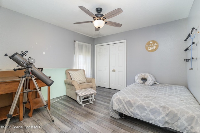 bedroom featuring ceiling fan, a closet, and hardwood / wood-style floors