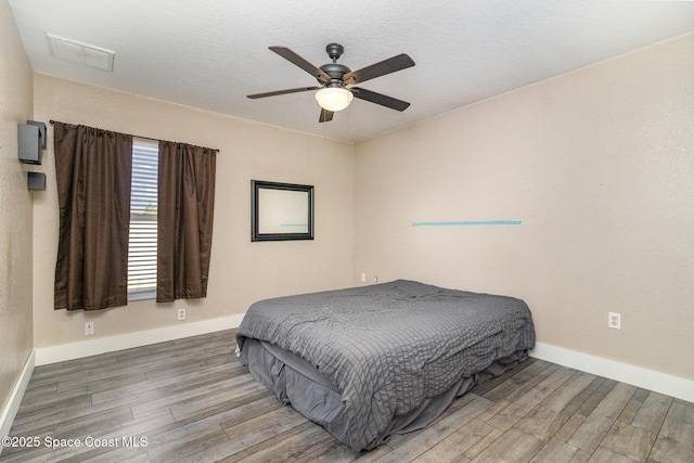 bedroom featuring wood-type flooring and ceiling fan