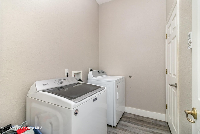 laundry room featuring light hardwood / wood-style flooring and washing machine and clothes dryer