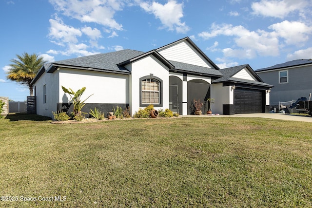 view of front facade with a garage and a front lawn