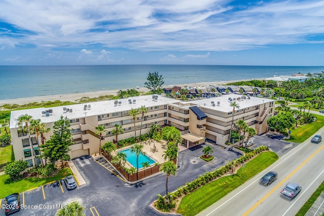 birds eye view of property with a water view and a view of the beach