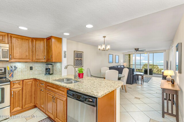 kitchen featuring kitchen peninsula, stainless steel appliances, and sink