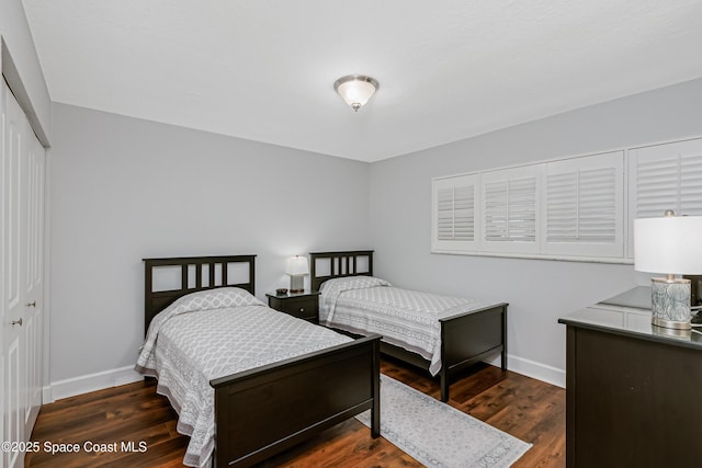 bedroom featuring dark hardwood / wood-style flooring and a closet